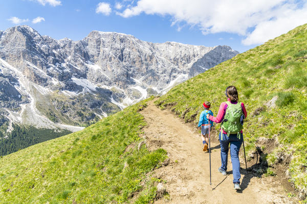 Cute little boy and mother admiring mountains from path during a hike, Duron Valley, Dolomites, Trentino Alto Adige, Italy