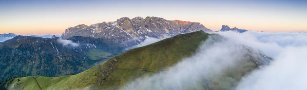 Mist at sunrise over Cime di Terrarossa, Catinaccio d'Antermoia, Molignon and Palacia, Seiser Alm, Dolomites, South Tyrol, Italy