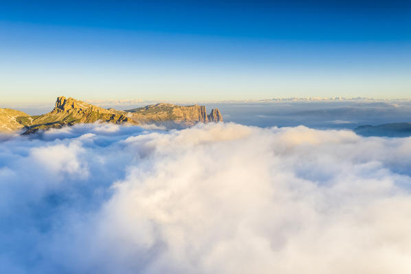 Peaks of Cime di Terrarossa and Sciliar emerging from a sea of clouds at dawn, Seiser Alm, Dolomites, South Tyrol, Italy