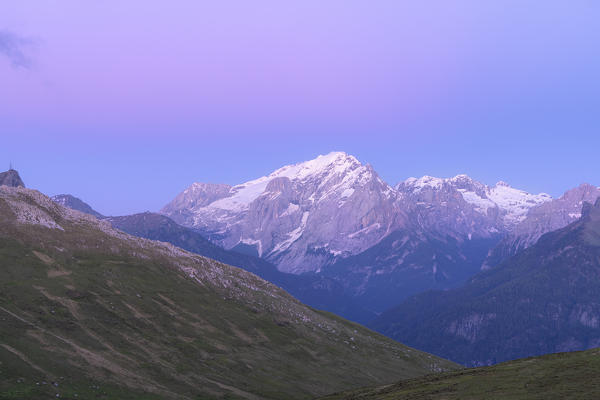 Pink sky at sunset over the majestic Marmolada mountain range, Dolomites, Trentino, Italy