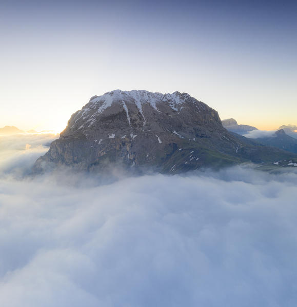 Sunrise over Sassopiatto emerging from mist, aerial view, Dolomites, Trentino-Alto Adige, Italy