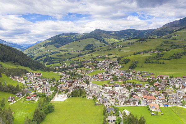 San Vigilio di Marebbe alpine village and green meadows in summer, aerial view, Dolomites, South Tyrol, Italy