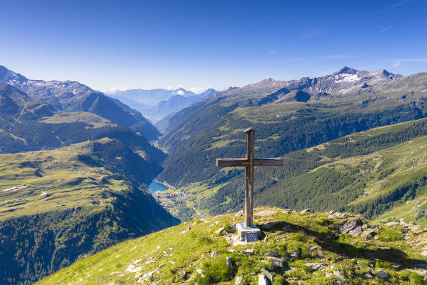 Cross on top of Mount Cardine overlooking Campodolcino, Isola and Andossi villages, Valchiavenna, Valtellina, Lombardy, Italy