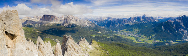 Aerial panoramic of Cortina d'Ampezzo and Tofane mountains surrounded by green woods, Dolomites, Belluno, Veneto, Italy