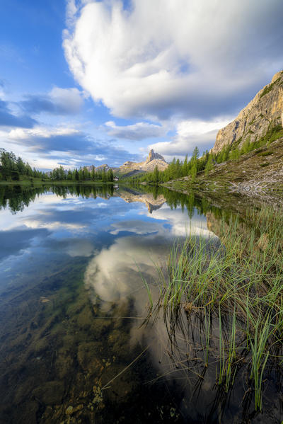 Clouds over Becco di Mezzodi reflected in the clear water of Lake Federa at dawn, Ampezzo Dolomites, Belluno, Veneto, Italy