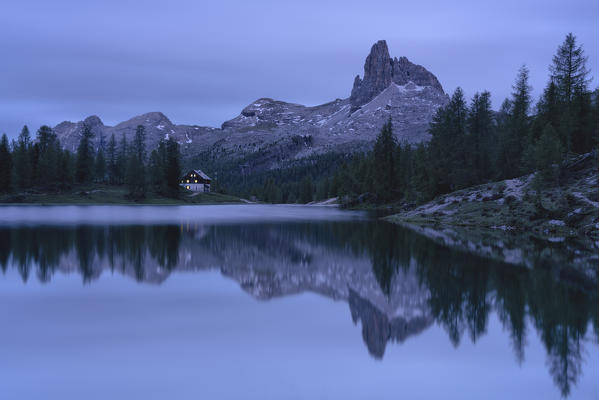 Dusk over Becco di Mezzodi and hut on shores of Lake Federa, Ampezzo Dolomites, Belluno province, Veneto, Italy