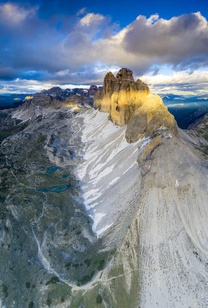 Aerial view of Grava Longa lakes at feet of majestic Tre Cime di Lavaredo at sunset, Sesto Dolomites, South Tyrol, Italy