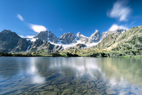 Bright blue sky on rocky peaks of Bernina Group and Forbici lake, Valmalenco, Valtellina, Sondrio province, Lombardy, Italy