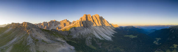 Aerial panoramic of Dolomites mountains of Puez-Odle nature park lit by sunset, South Tyrol, Bolzano province, Dolomites, Italy