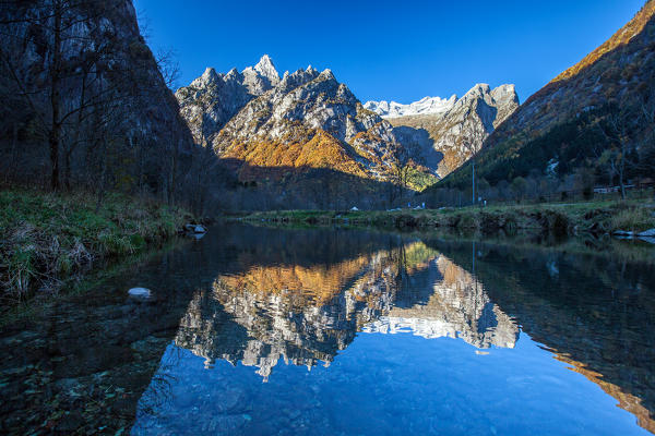 Morning reflections in the Masino creek, where the peaks of Cavalcorto and of Val del Ferro are reflected. Valmasino, Lombardy, Valtellina Italy Europe