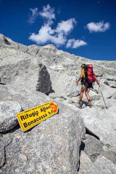 Hiker walking on the Sentiero Roma which takes to Allievi Refuge, Valmasino. Valtellina Lombardy Italy Europe