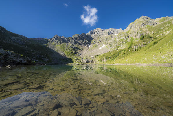 Summer sky over the transparent water of Torena lakes, Orobie Alps, Aprica, Val Belviso, Valtellina, Sondrio, Lombardy, Italy