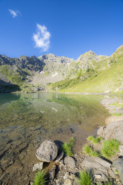 Mountains reflected in the clear water of Torena lakes, Orobie Alps, Aprica, Val Belviso, Valtellina, Sondrio, Lombardy, Italy