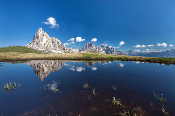 Gusela and Tofane reflected in a puddle. Giau Pass, Cortina d'Ampezzo, Veneto Italy Europe