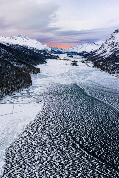 Ice and snow covering Lake Silvaplana during the winter sunrise, aerial view, Maloja, Engadine, Graubunden canton, Switzerland