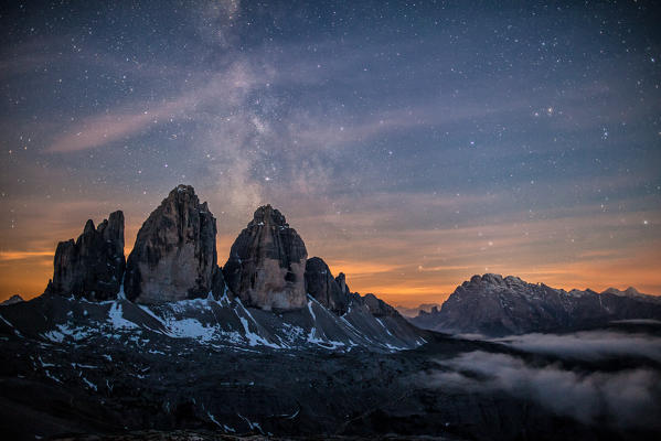 The Milky Way with its stars appear in a summer night on the  Three Peaks of Lavaredo. Dolomites. Veneto.Italy. Europe