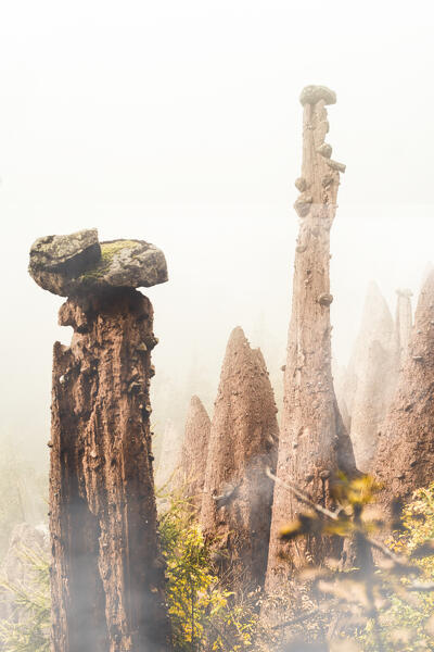 Natural monuments of the earth pyramids in the mist of autumn, Renon/Ritten, Bolzano, South Tyrol, Italy