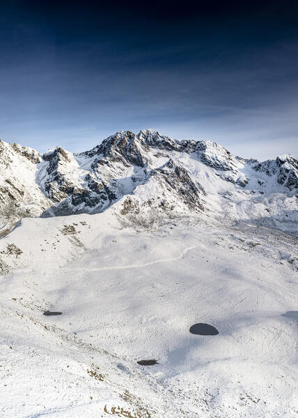 Aerial view of majestic snowcapped Vetta di Rhon peak in autumn, Piani di Rhon, Rhaetian Alps, Sondrio, Lombardy, Italy