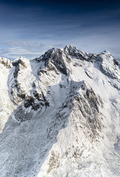 Rocky peak of Vetta di Rhon mountain covered with snow, aerial view, Rhaetian Alps, Sondrio, Lombardy, Italy