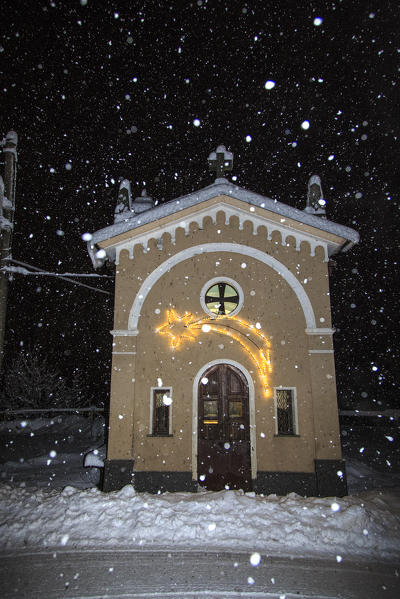 The little church of Cimaganda under a thick snowfall. Campodolcino, Vallespluga, Valchiavenna, Valtellina Lombardy Italy Europe