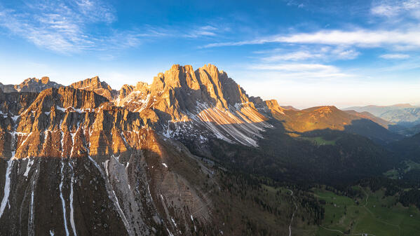 Majestic rocks of the Odle group lit by sunrise, aerial view,  Funes Valley, Dolomites, South Tyrol, Italy