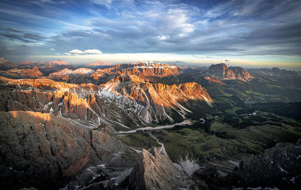 Dramatic sky at sunset over Sassolungo group, Sassopiatto, Sella, Gardena Valley, aerial view, Dolomites, South Tyrol, Italy