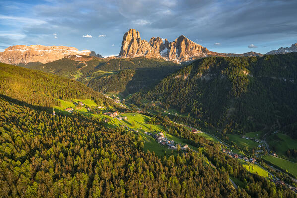 Aerial view of Sassolungo group, Sassopiatto, Gardena Valley and  at sunset in spring, Dolomites, South Tyrol, Italy