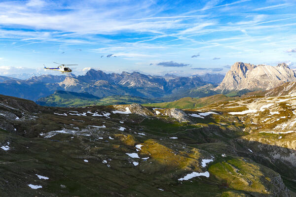 Helicopter flying towards Sciliar massif, Sassopiatto and Sassolungo, aerial view, Dolomites, South Tyrol, Italy