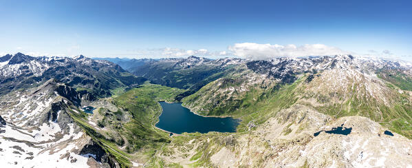 Aerial panoramic of the alpine lake Montespluga in summer, Madesimo, Valle Spluga, Valtellina, Lombardy, Italy