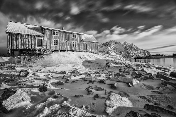 Black and white photo depicting a house in Henningsvaer. Lofoten Islands. Norway. Europe