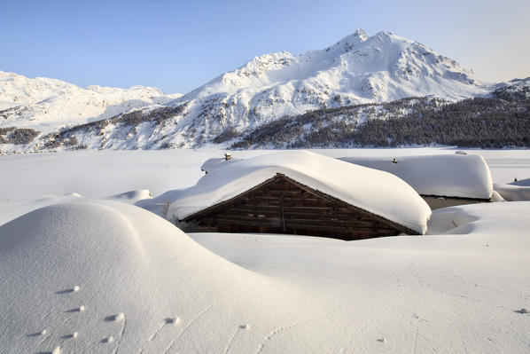 Spluga huts almost submerged by snow. Engadine. Switzerland. Europe