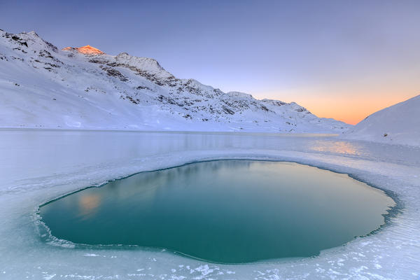 Puddle in the middle of Lake Bianco the only point where the water rises to the surface. Bernina Pass. Canton of Graubunden. Engadine. Switzerland. Europe 