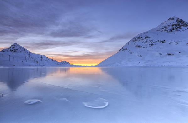 Sunrise over Lake Bianco completely frozen. Bernina Pass. Canton of Graubunden. Engadine. Switzerland. Europe 