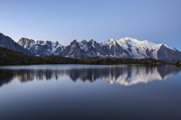 The Mont Blanc mountain range reflected in the waters of Lac de Chesery at sunrise. Haute Savoie France Europe