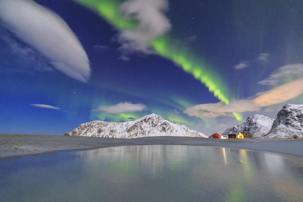 Norhtern Lights and snow covered mountains. Flakstad. Lofoten Islands Norway Europe