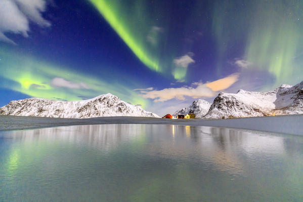 Norhtern Lights and snow covered mountains. Flakstad. Lofoten Islands Norway Europe