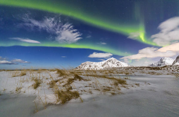 Northern Lights illuminate Flakstad sky. Lofoten Islands Northern Norway Europe