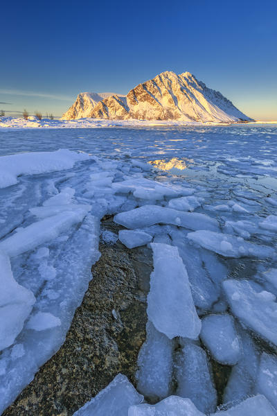 Views of the mountains of Gymsøya from Smorten where sea is almost completely frozen. Lofoten Islands Norway Europe