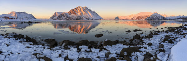 Panoramic view of  Gymsøya mountains  reflected in the cold sea. Lofoten Islands Norway Europe