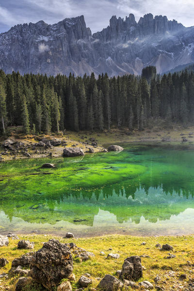 Latemar group reflected in the green waters of Lake Carezza. Ega Valley Dolomites South Tyrol Trentino Alto Adige Italy