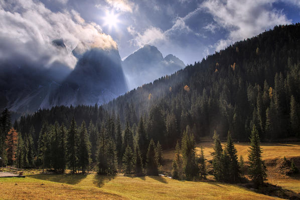 Colorful woods in autumn frame the Odle. Malga Zannes. Funes Valley South Tyrol Dolomites Italy Europe