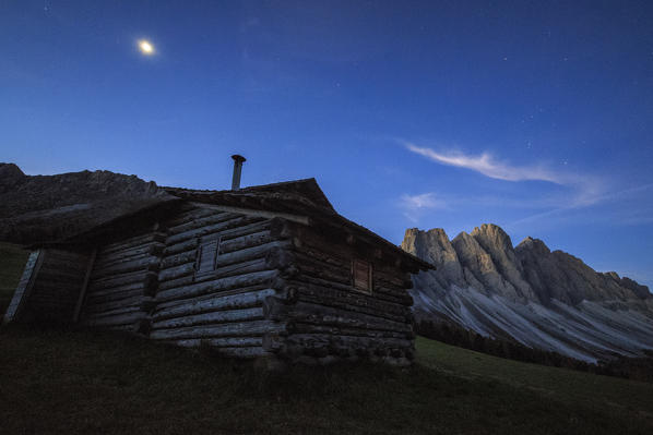 The early morning light illuminates Malga Zannes and the Odle in background. Funes Valley South Tyrol Dolomites Italy Europe