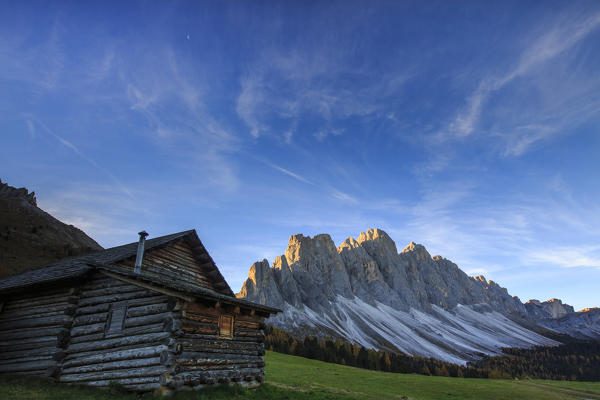 The early morning light illuminates Malga Zannes and the Odle in background. Funes Valley South Tyrol Dolomites Italy Europe