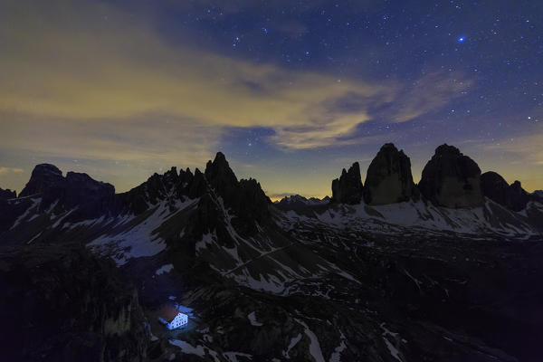 Night sky above Refuge Locatelli and the three peaks of Lavaredo. Trentino Alto Adige Sesto Dolomites Italy