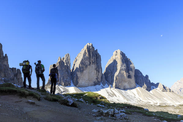 Hikers admire the Three Peaks of Lavaredo. Sesto Dolomites Trentino Alto Adige Italy Europe