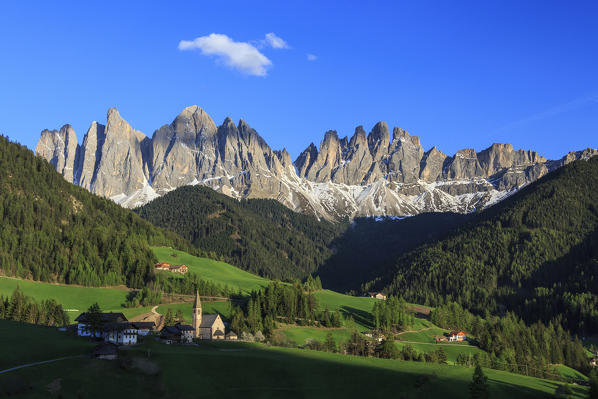 The village of St. Magdalene surrounded by green meadows at the foot of the Odle Funes Valley South Tyrol Dolomites Italy Europe