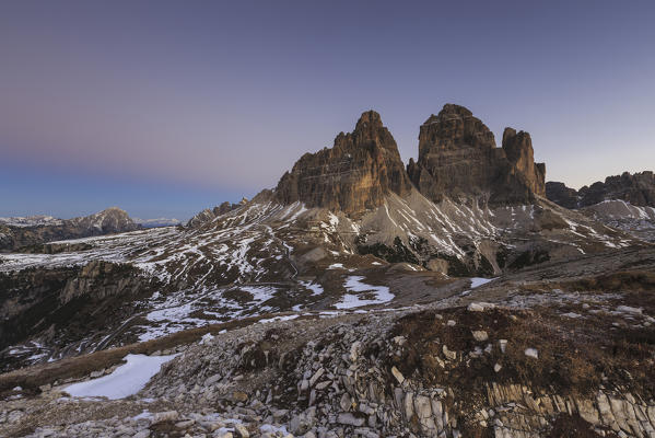 Pink sky at sunrise frames the Three Peaks of Lavaredo Dolomites Auronzo of Cadore Veneto Italy Europe