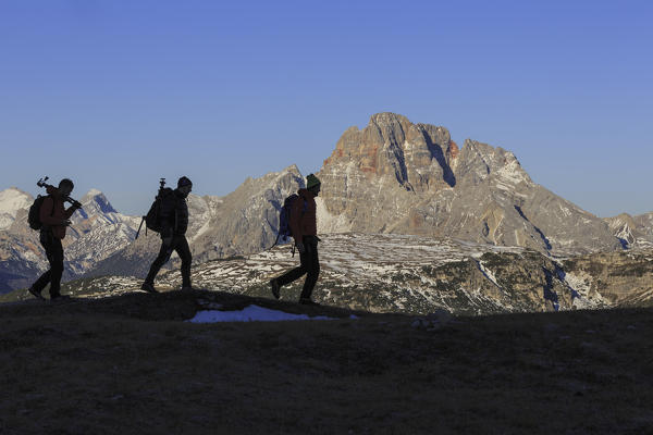 Hikers at sunrise Three Peaks of Lavaredo Dolomites Auronzo of Cadore Veneto Italy Europe