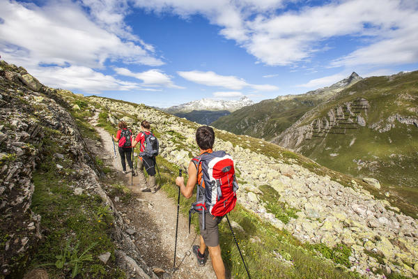 Hikers admire the view on the Alps Engadine Canton of Grisons Switzerland Europe