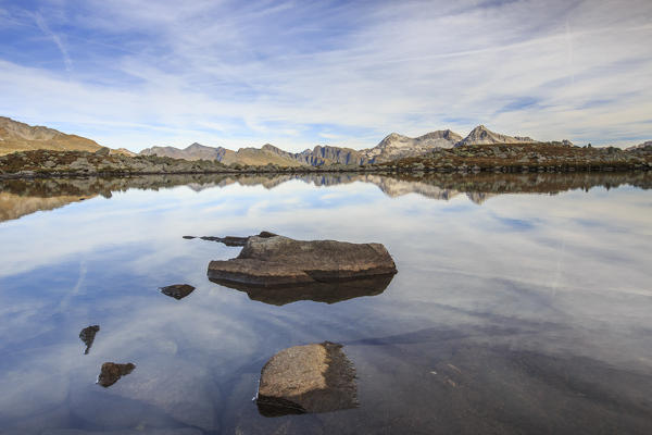 Peaks are reflected in Lake Bergsee at dawn Chiavenna Valley Spluga Valley Switzerland Europe